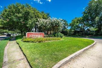 Houston apartment for rent - a park with a red and white sign in the grass