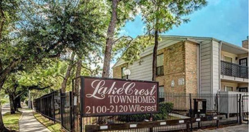 Houston apartment for rent - an apartment building with a sign in front of it