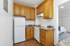 San Francisco apartment for rent - a kitchen with white appliances and wooden cabinets