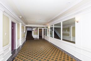 San Francisco apartment for rent - a large hallway with windows and a carpeted floor