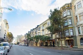 San Francisco apartment for rent - a city street with cars parked on the side of a row of buildings