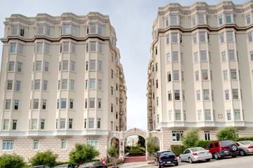 San Francisco apartment for rent - A large, two-story building with a white facade and multiple windows.