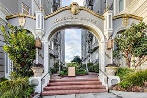 San Francisco apartment for rent - A white building with a red staircase leading to a sign that says "Lombard Place".