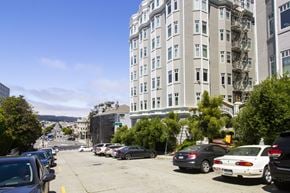 San Francisco apartment for rent - A parking lot with cars and a building in the background.