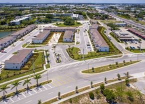 Miami apartment for rent - an aerial view of a parking lot with cars and buildings