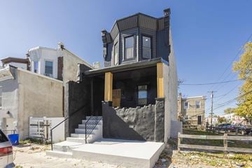 Philadelphia house for rent - A modern house with a black exterior and a large window.