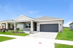 Kissimmee house for rent - A house with a grey garage door and a white driveway.