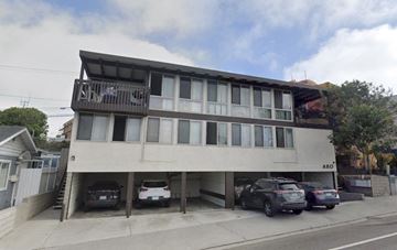 Manhatten Beach apartment for rent - a large white building with cars parked in front of it