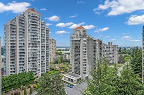 New Westminster apartment for rent - A view of a residential area with multiple apartment buildings and a parking lot.