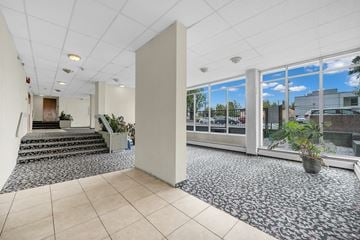 New Westminster apartment for rent - A spacious office with a view of the outdoors through large windows.