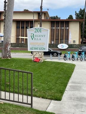 Long Beach apartment for rent - a sign in the grass in front of a building