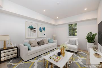 San Francisco apartment for rent - A living room with a white couch, a coffee table, and a painting on the wall.