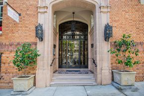 San Francisco apartment for rent - A building with a glass door flanked by two planters.