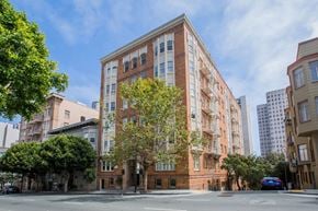 San Francisco apartment for rent - A tall red brick building with a tree in front of it.