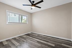 Brea apartment for rent - an empty bedroom with a ceiling fan and a window