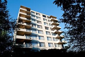 Vancouver apartment for rent - A tall residential building with balconies on the upper floors.