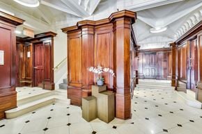 San Francisco apartment for rent - A hallway with wooden doors and a chandelier.