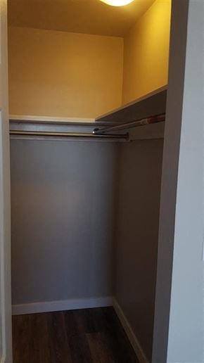 New Westminster apartment for rent - A small, empty room with a grey wall and a wooden floor.