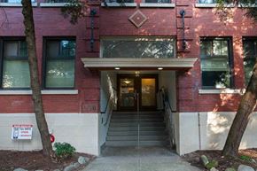 Vancouver apartment for rent - A red building with a white sign on the left side.