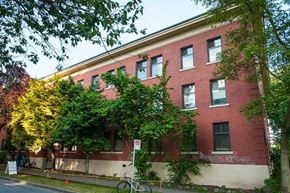 Vancouver apartment for rent - A red brick building with a no parking sign in front.