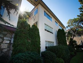 Victoria apartment for rent - A white building with a green tree in front of it.