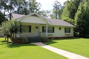 Hattiesburg house for rent - a small white house with a sidewalk in front of it