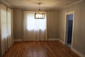 Hattiesburg house for rent - a dining room with a large window and a chandelier