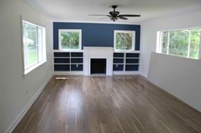 Hattiesburg house for rent - a living room with a hard wood floor and a fireplace