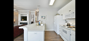 Greer house for rent - a kitchen with white cabinets and a white counter top