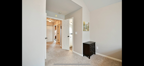 Greer house for rent - a hallway with a dresser and a hall way to a bedroom and a bathroom