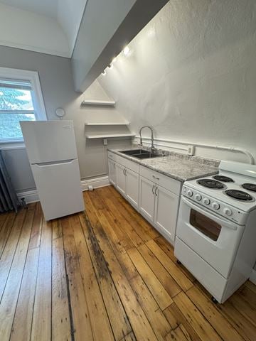 Duluth apartment for rent - A kitchen with a white stove and refrigerator.