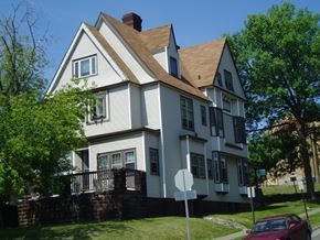 Duluth apartment for rent - A white house with a red car parked in front.