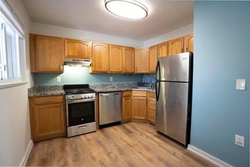 Annapolis apartment for rent - A kitchen with wooden cabinets and a stainless steel refrigerator.