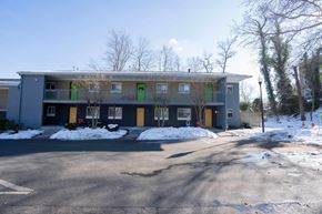 Annapolis apartment for rent - A grey building with green doors and windows.