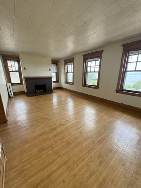 Duluth apartment for rent - A room with wooden floors and a fireplace.