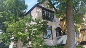 Duluth apartment for rent - A house with a white fence and a tree in front of it.