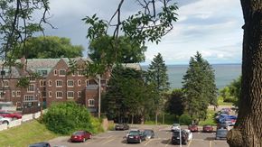 Duluth apartment for rent - A parking lot with cars and a building in the background.