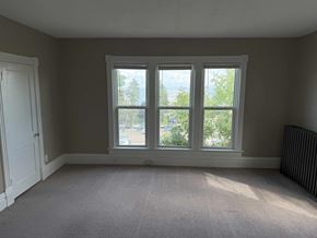 Duluth apartment for rent - A room with a carpeted floor and a large window.