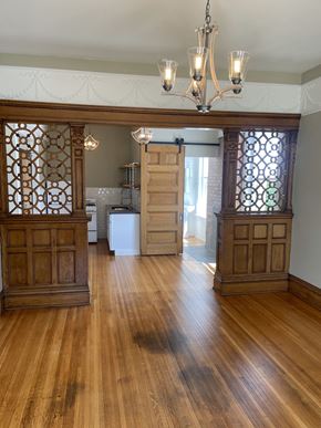 Duluth apartment for rent - A room with wooden floors and a chandelier.