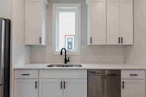 New Richmond house for rent - a kitchen with white cabinets and a window above the sink