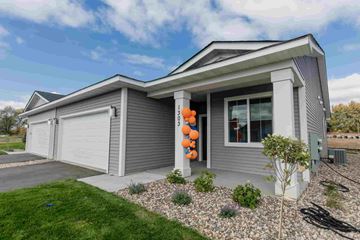 New Richmond house for rent - a with a garage and a yard with a pumpkin decoration