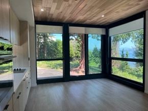 Vancouver apartment for rent - A modern kitchen with a view of the forest outside.