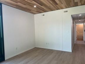 Vancouver apartment for rent - A room with a wooden ceiling and light brown flooring.