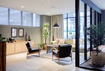 Stamford apartment for rent - A modern living room with a black chair and a wooden cabinet.