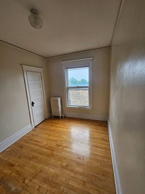 Duluth apartment for rent - A room with a wooden floor and a window.