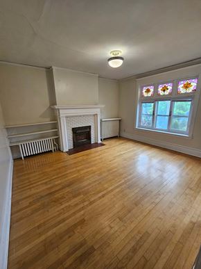 Duluth apartment for rent - A room with a fireplace and a stained glass window.