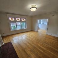 Duluth apartment for rent - A room with a window and wooden floors.