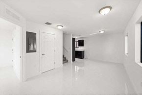 Miami apartment for rent - an empty white room with a white door and a staircase