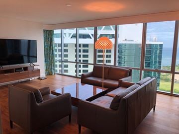 Honolulu apartment for rent - A living room with brown leather furniture and a flat screen TV.