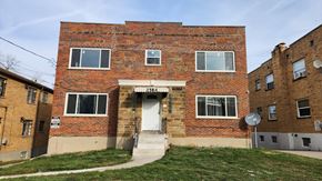 Cincinnati apartment for rent - an old brick building with a white door and stairs